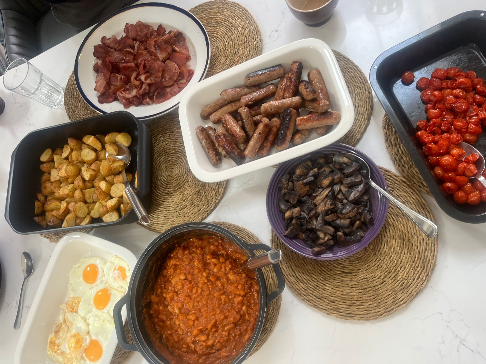Breakfast Buffet with Sausages, Potatoes & Tomatoes.