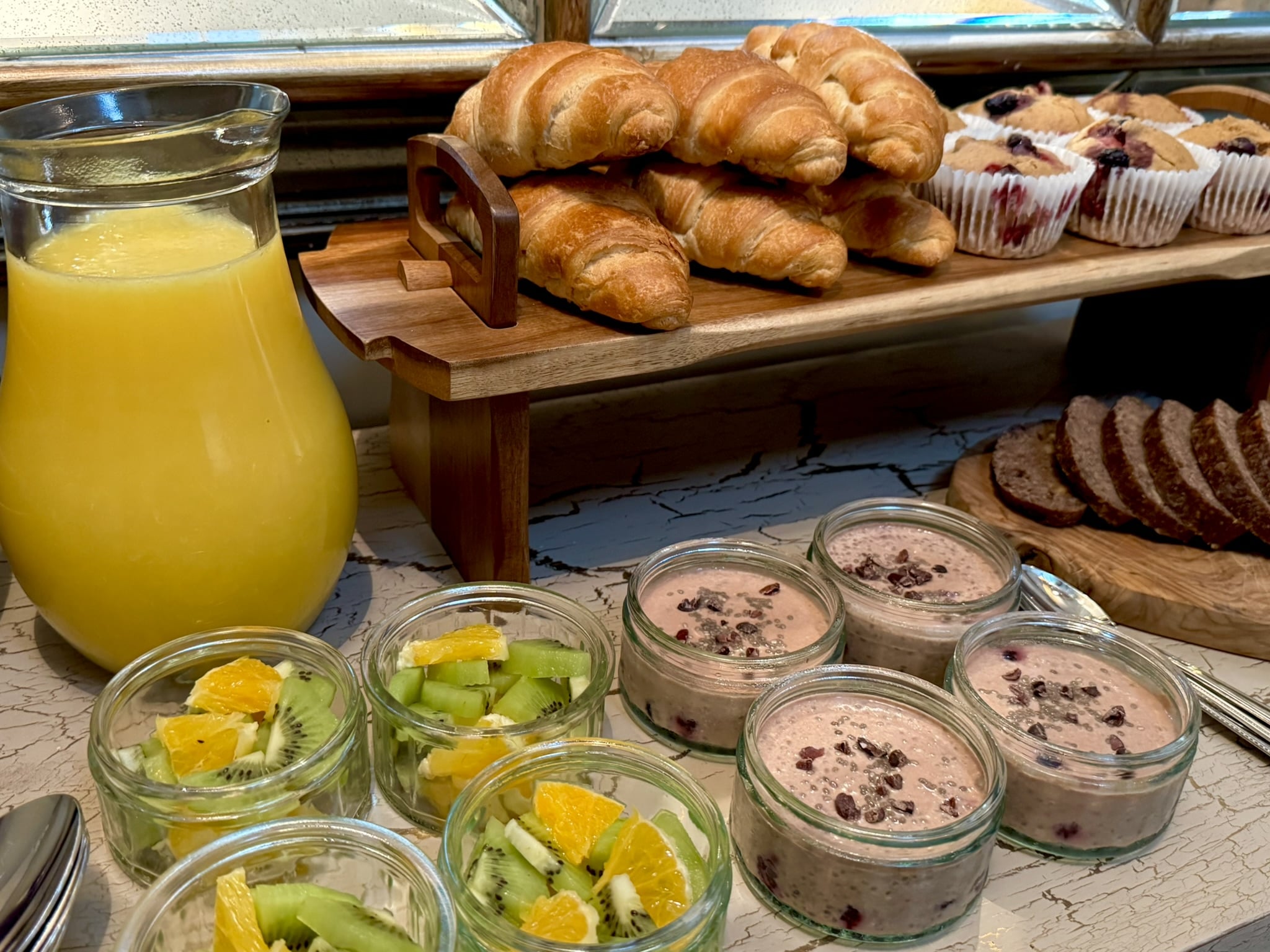 Buffet, with orange juice, Bread, Fruit & Cake.