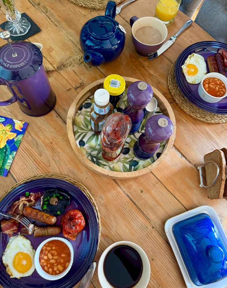 Picture of Breakfast food and Sauces atop a Dining Table.