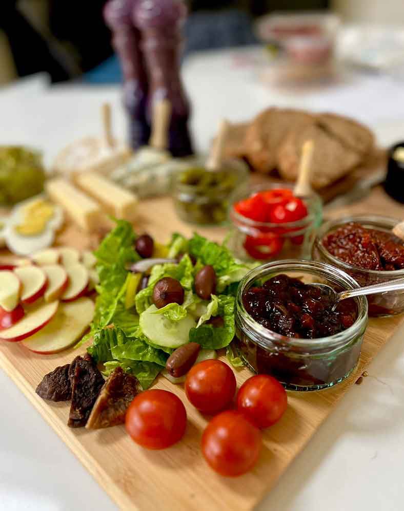 Dinner containing various vegetables, fruits and condiments