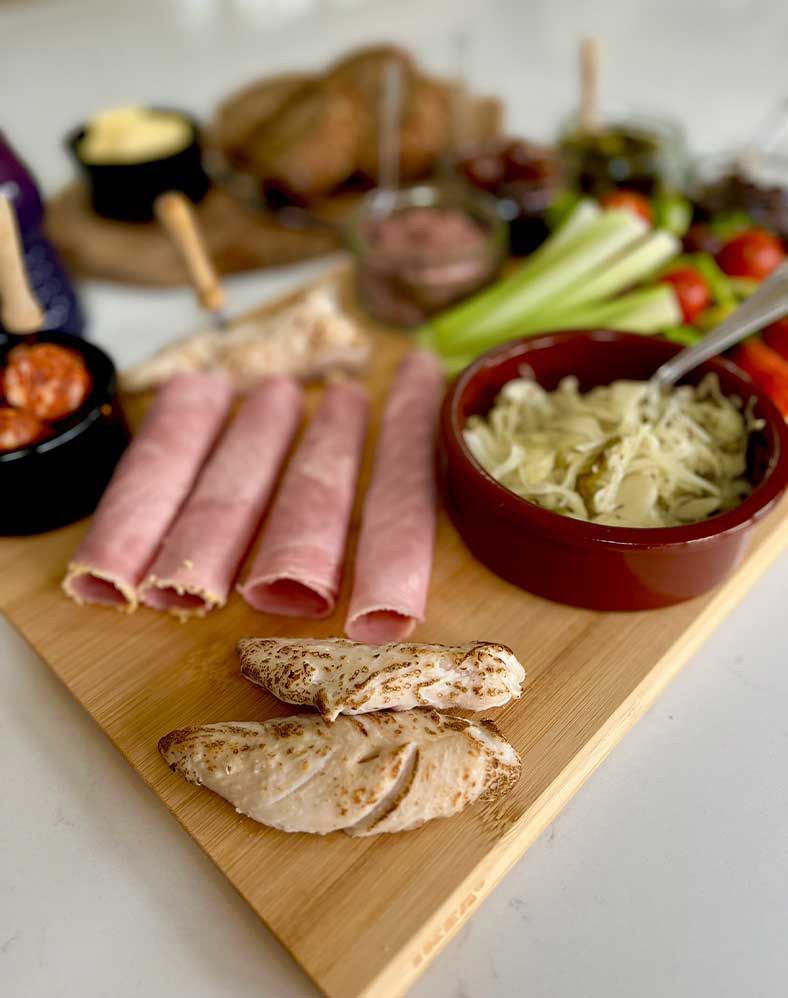 Dinner containing Ham, chicken and vegetables